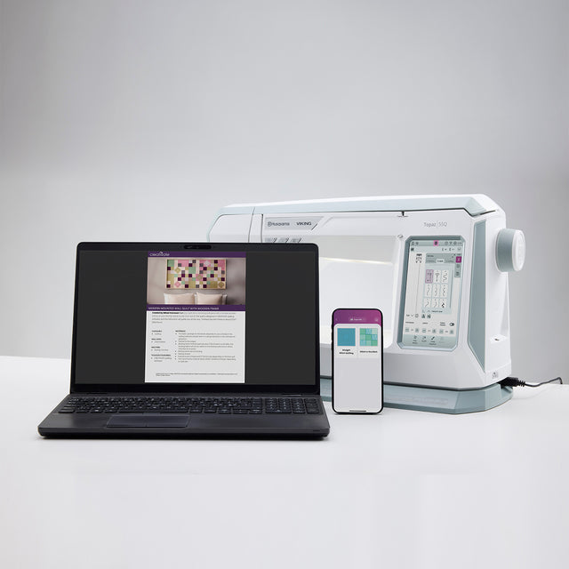 Laptop, smartphone, and medical device on a white surface with a gray background