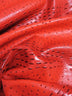 Tejido de vinilo con relieve de cocodrilo y avestruz mutante en color rojo Carnage / Se vende por metros
