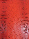 Tejido de vinilo con relieve de cocodrilo y avestruz mutante en color rojo Carnage / Se vende por metros