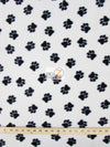 Tejido de felpa con estampado de huellas de animales en blanco y negro