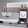 Sewing machine with digital display and embroidery design on a gray background