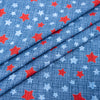 Tela SINGER®, 100 % algodón, con estrellas rojas y azules sobre fondo texturizado, vendida por metros