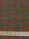 Tela de poliéster y algodón verde con motivos de calabazas de Halloween